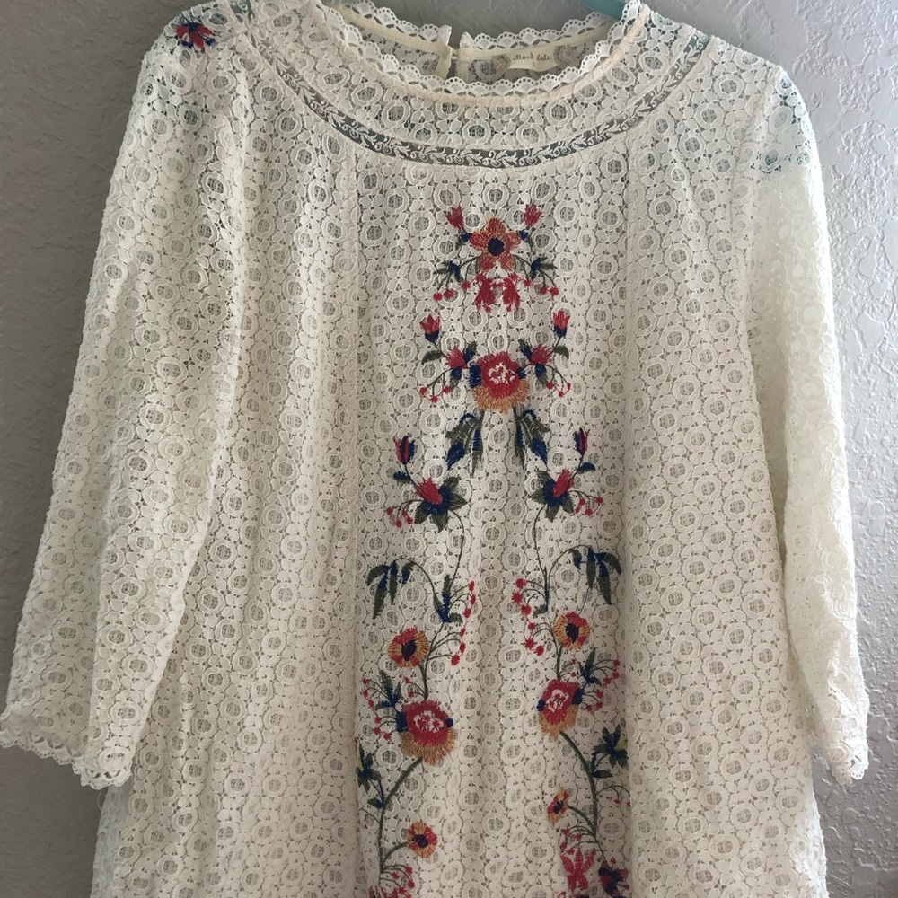 A white blouse w/ embroidery pattern